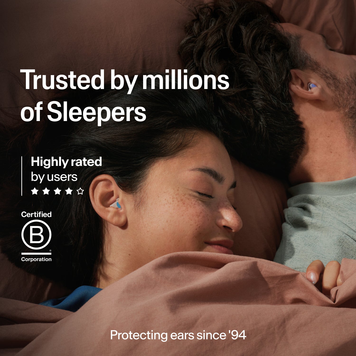 Couple asleep wearing Alpine SleepDeep Multisize earplugs, trusted by millions, B Corp certified and protecting ears since 1994