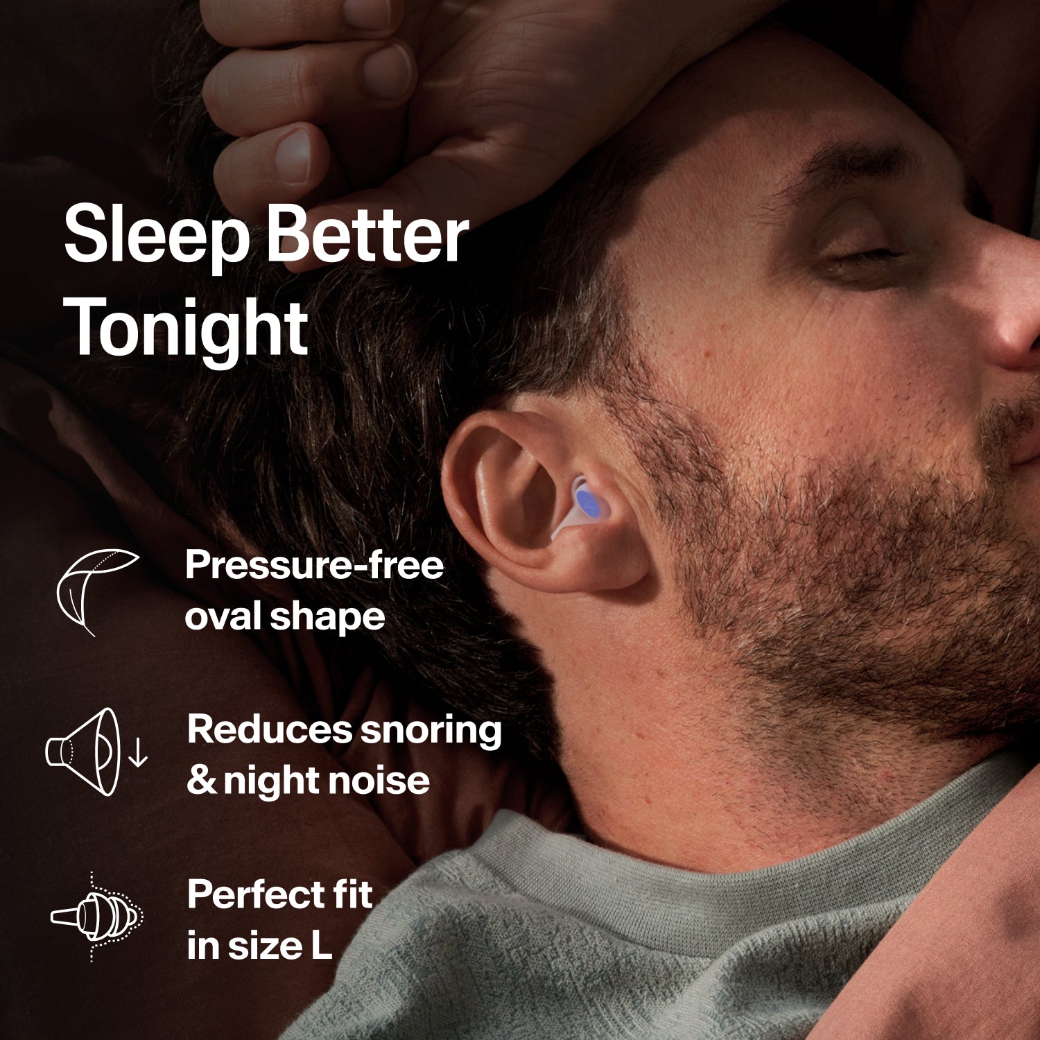 Man asleep on his side wearing an Alpine SleepDeep earplug, size L, to block snoring and night noise 